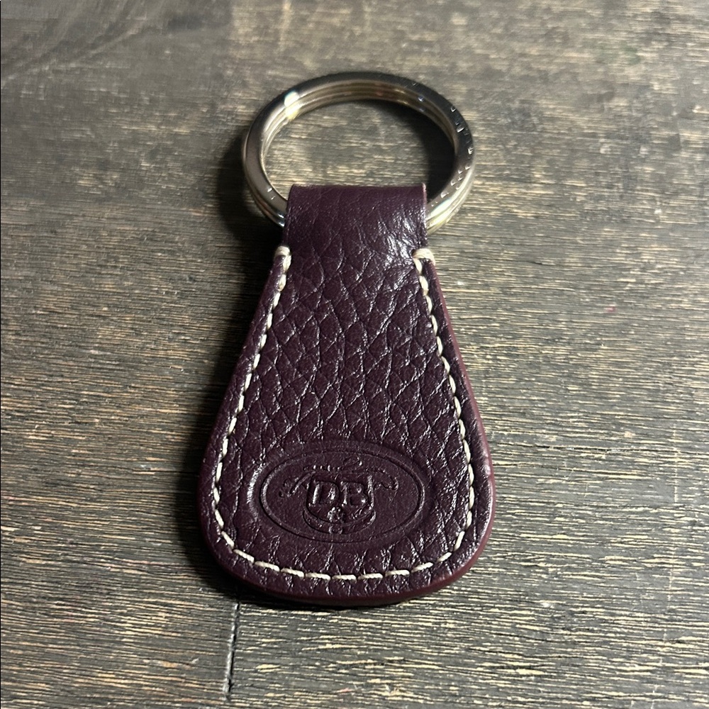 Dooney & Bourke leather key fob, featuring an embossed logo‎ dark plum